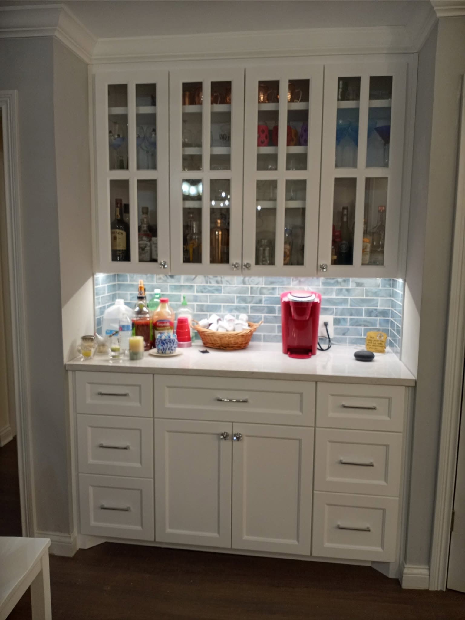 Custom white hutch and buffet with glass doors and tile backsplash