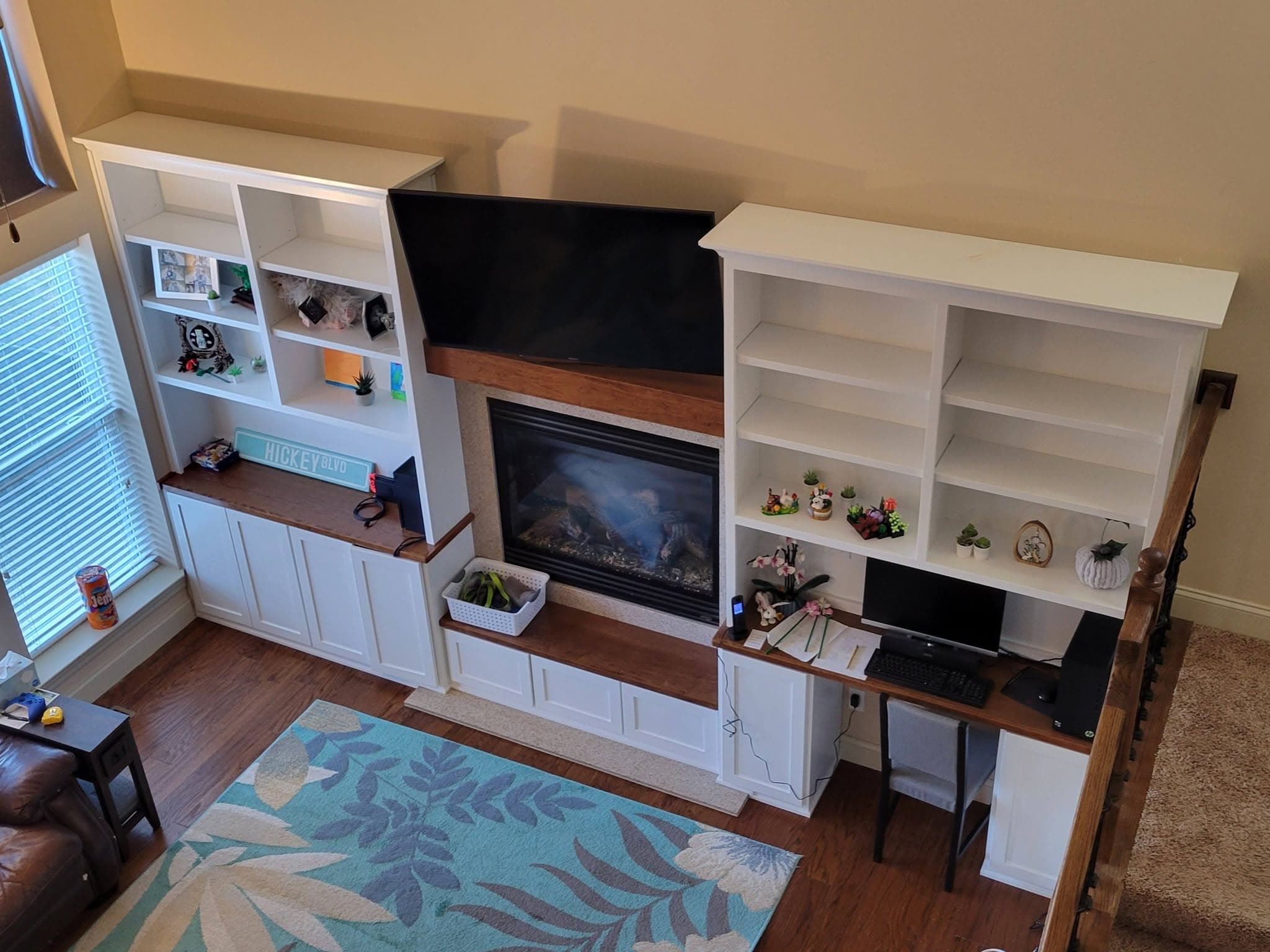White entertainment center with fireplace, shelving and built-in desk